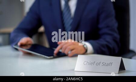 Chief of staff working on tablet pc, managing country presidents schedule Stock Photo