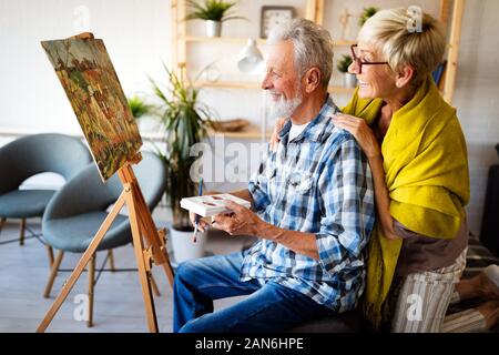 Loving senior couple relaxing at home. Mature husband and wife spending time together