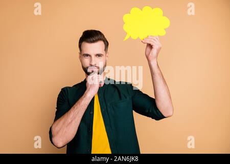 Photo of attractive nice guy holding hand paper cloud deep thinking about dialogue answer creative person arm on chin wear casual hipster clothes Stock Photo