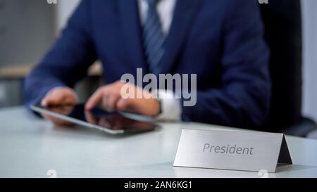 Country president viewing files on tablet pc, preparing for public presentation Stock Photo