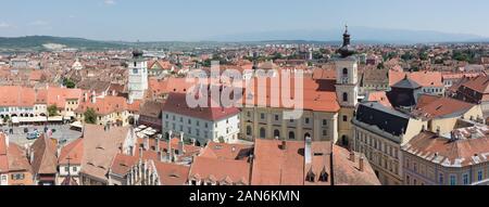 Panorama view of Sibiu Old Town. On the right the Roman Catholic Church, on the left the market square. Sibiu was European Capital of Culture in 2007. Stock Photo