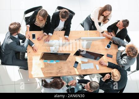 top view. happy employees shaking hands during a meeting Stock Photo