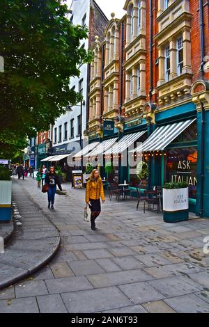 A street view of Mill Lane in Cardiff city centre. Features a collection of restaurants, bars & cafés, popular with visitors & locals. Outdoor dining. Stock Photo