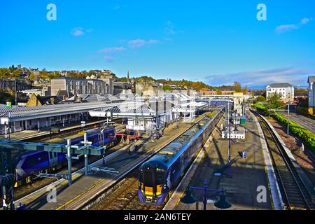 View of Stirling railway station with part of the old town in view in background.Modern trains arriving & departing. Stock Photo