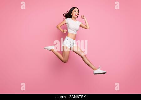 Full length body size view of her she nice attractive lovely dreamy purposeful cheerful cheery wavy-haired girl jumping having fun running fast Stock Photo