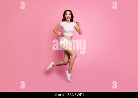 Full length body size view of her she nice attractive lovely charming sportive cheerful cheery wavy-haired girl jumping running having fun motion Stock Photo