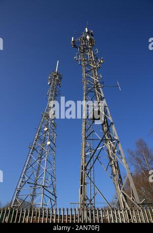 Telecommunication towers against a blue sky. Stock Photo