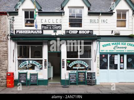 CONWY, UK - February 26, 2012. Outside a traditional fish and chip shop on a street in Wales Stock Photo