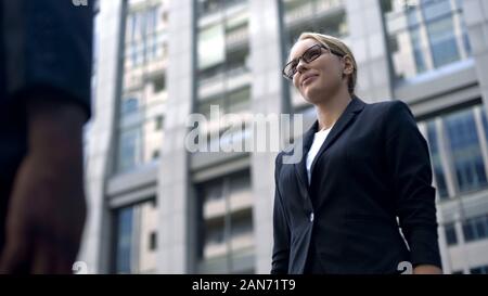 Business woman meeting partner at airport, important negotiations, agreement Stock Photo