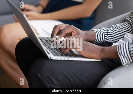 Close up of african American male typing using laptop Stock Photo