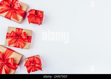 Frame of cardboard gift boxes with red bows. Stock Photo