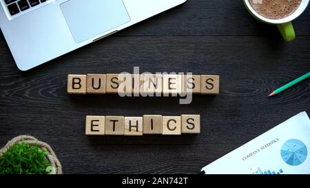 Business ethics phrase made of wooden cubes, behavior rules in company team Stock Photo