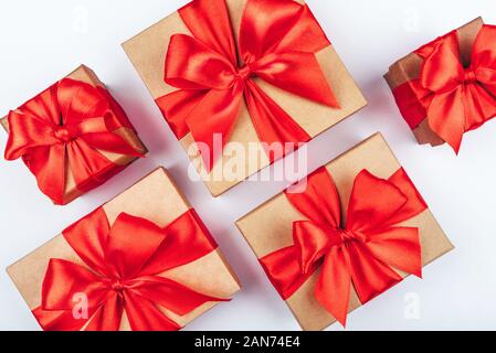 Cardboard gift boxes with red bows on white background. Stock Photo