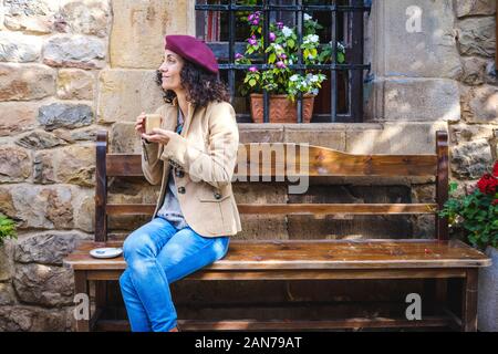 White woman in casual dress enjoying her coffee outside Stock Photo
