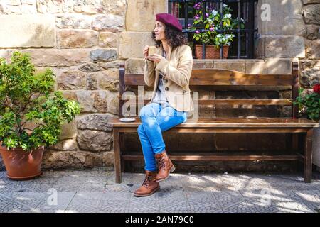 White woman in casual dress enjoying her coffee outside Stock Photo