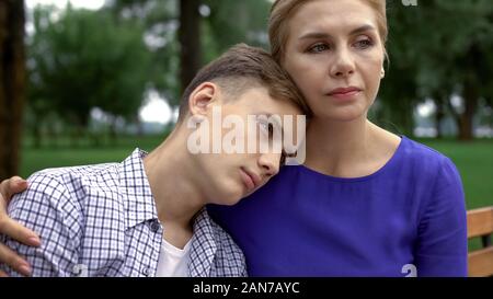 Portrait Of Upset Teen Boy In Sportswear Scolded By Mother At