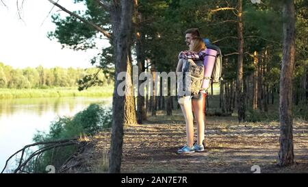 Loving hikers couple embracing and enjoying beautiful river view, romantic trip Stock Photo