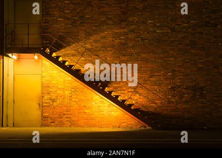 illuminated metal stair at night, simple stairway at night, colorful photo, golden look Stock Photo