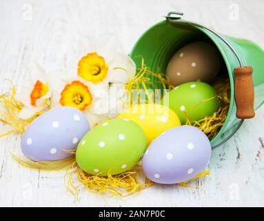 easter eggs in little buckets with daffodil flowers Stock Photo