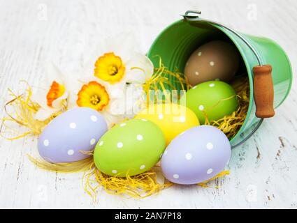 easter eggs in little buckets with daffodil flowers Stock Photo