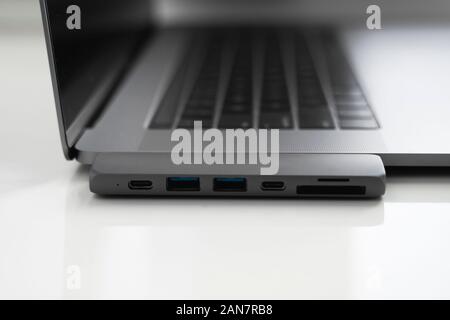 The USB adapter under the Type-C connector for laptop. Multiport station for laptop with multiple different ports. USB to USB Type-C Hub Converter Stock Photo