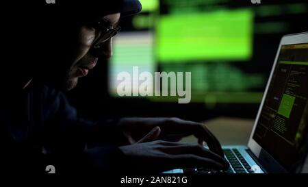Programmer hacking security system, unauthorized remote control of database Stock Photo