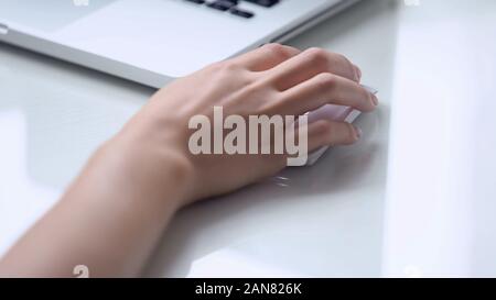 Hand using wireless mouse with laptop, personal computer use for office work Stock Photo