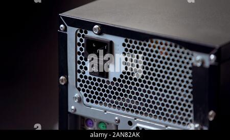 Back panel of computer system block with power button and connectors electricity Stock Photo