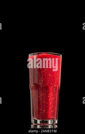 Raspberry Smoothie or Shake in a Glass isolated on black Background Stock Photo