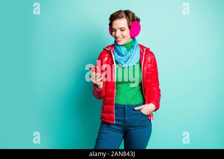 Guys I'm already here. Photo of pretty lady chatting telephone writing friends waiting meeting wear casual red coat scarf pink ear covers sweater Stock Photo