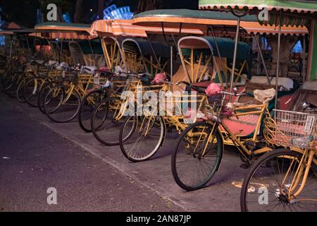 Empty typical chinese rickshaws on night street of Macau Stock Photo