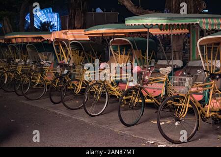 Empty typical chinese rickshaws on night street of Macau Stock Photo