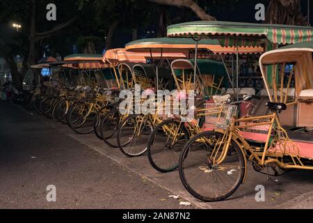 Empty typical chinese rickshaws on night street of Macau Stock Photo