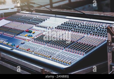 Mixer for editing sound on channels. Sound device with tumblers for adjusting sound tones. Digital audio amplifier. Sound Engineer Tool. Stock Photo