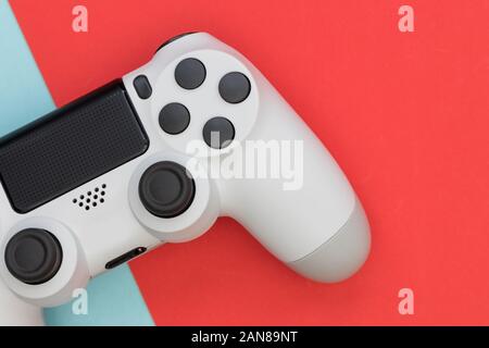 Video game gaming controller on bright red blue color background top view Stock Photo