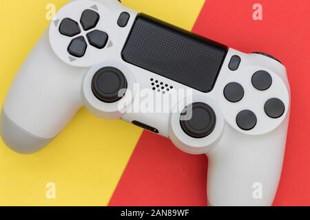 Video game gaming controller on bright red yellow color background top view Stock Photo