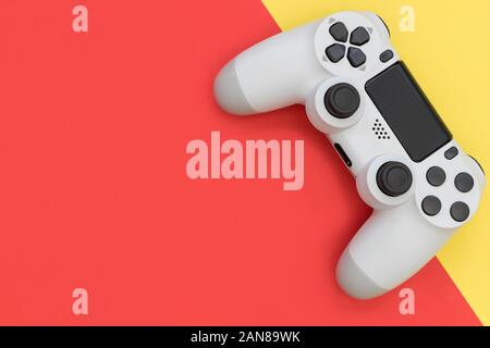 Video game gaming controller on bright red yellow color background top view Stock Photo