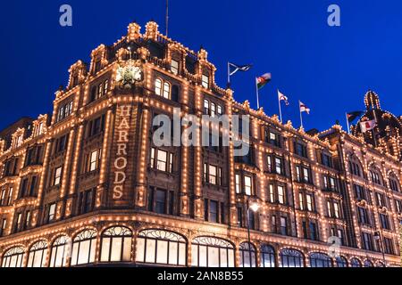 LONDON - DECEMBER 18, 2019: Harrods London department store shop at night with lights Stock Photo