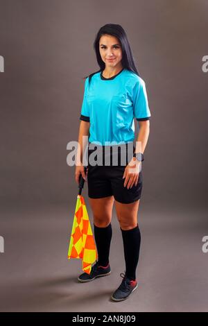 Beautiful Soccer Referee with flag in hand looking at camera and smile Stock Photo