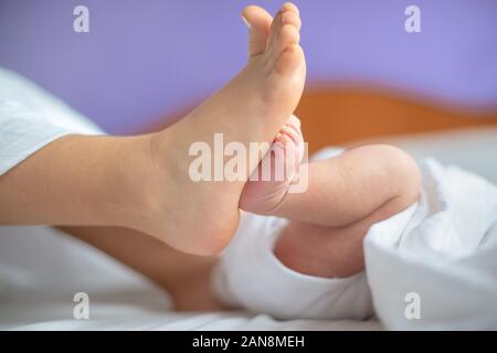 Newborn baby and toddler feet Stock Photo