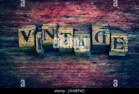 Vintage wooden stamps text letters, faded grunge wooden background Stock Photo