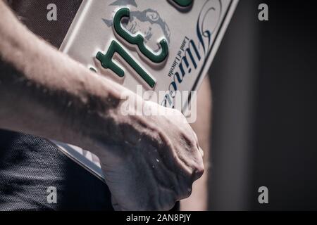 American Car License Plate. State of Illinois DMV. Men with Plate in Hands Closeup Photo. Stock Photo