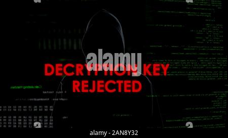 Decryption key rejected, unsuccessful attempt to hack account, coder in hoodie Stock Photo
