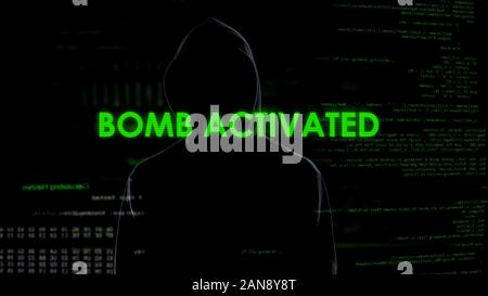 Faceless male hacker remotely activating bomb, terrorism, cyber crime concept Stock Photo