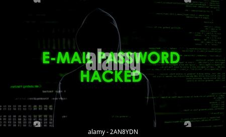 E-mail password hacked, criminal in black gets unauthorized access to data Stock Photo