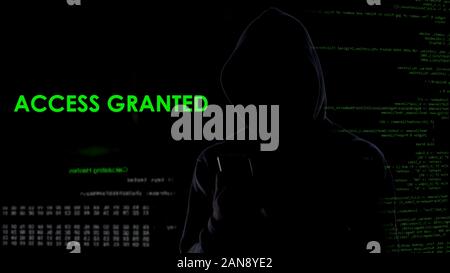 Computer genius man hacking e-mail from cellphone, access granted, cybercrime Stock Photo