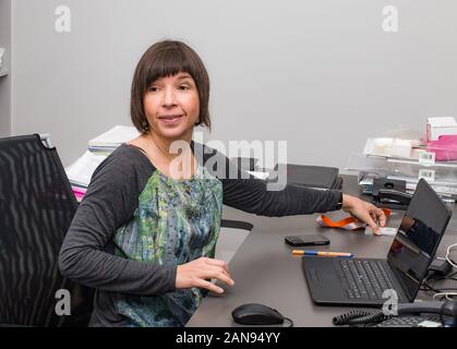 Successful happy and smiling woman at work in the office box, Stock Photo
