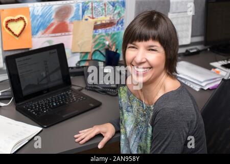 Successful happy and smiling woman at work in the office box, Stock Photo