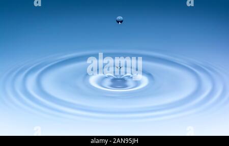 Drops of water dripping on water surface Stock Photo