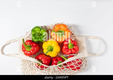 Zero waste concept. Vegetables in eco friendly reusable string bag on white background. Plastic free. Healthy fresh vegetarian food. Flat lay Stock Photo
